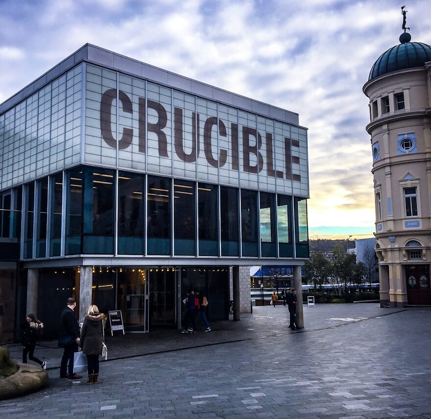 white and brown Crucible signage during daytime